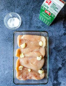 crushed garlic over raw chicken