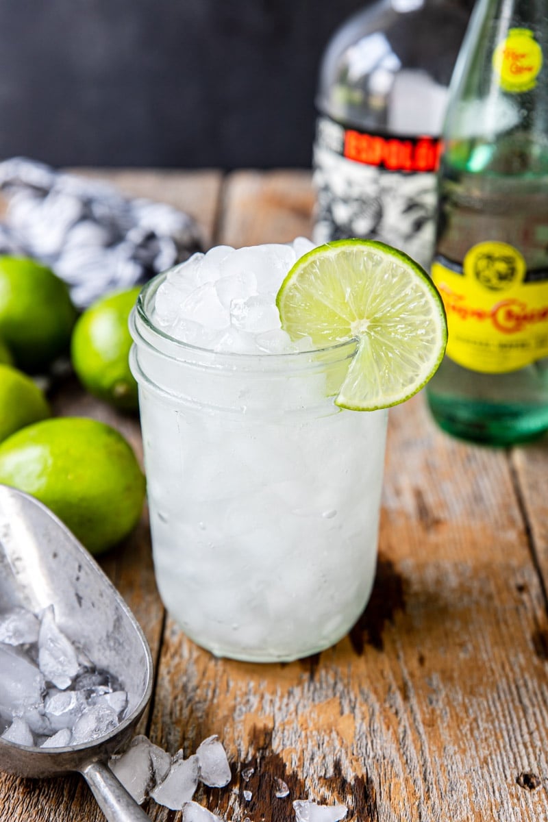 tequila ranch water in a glass with crushed ice and a lime wheel