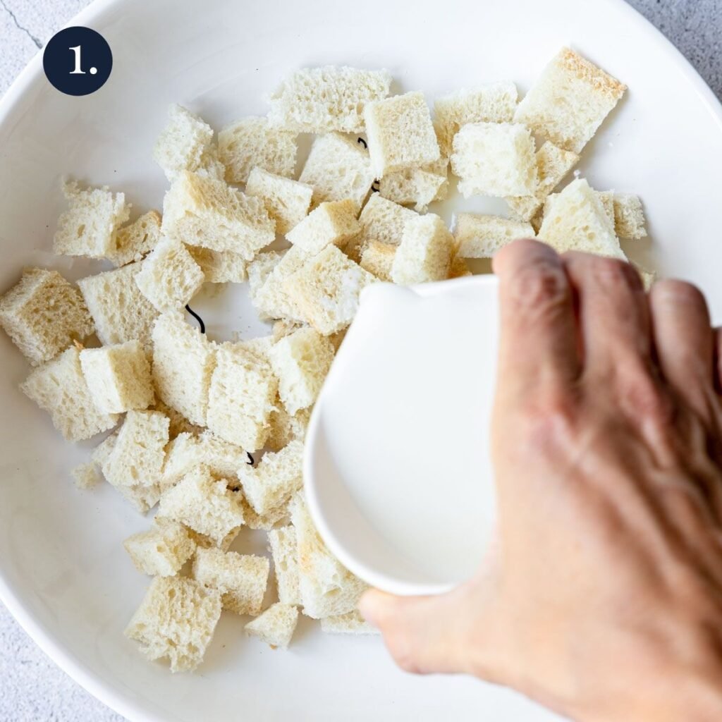 pouring milk over bread cubes