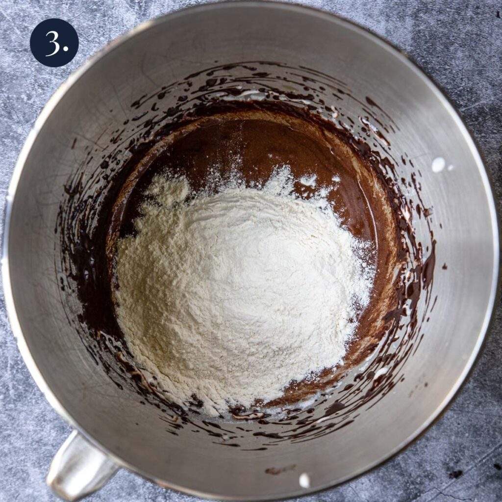 flour on top of a chocolate mixture
