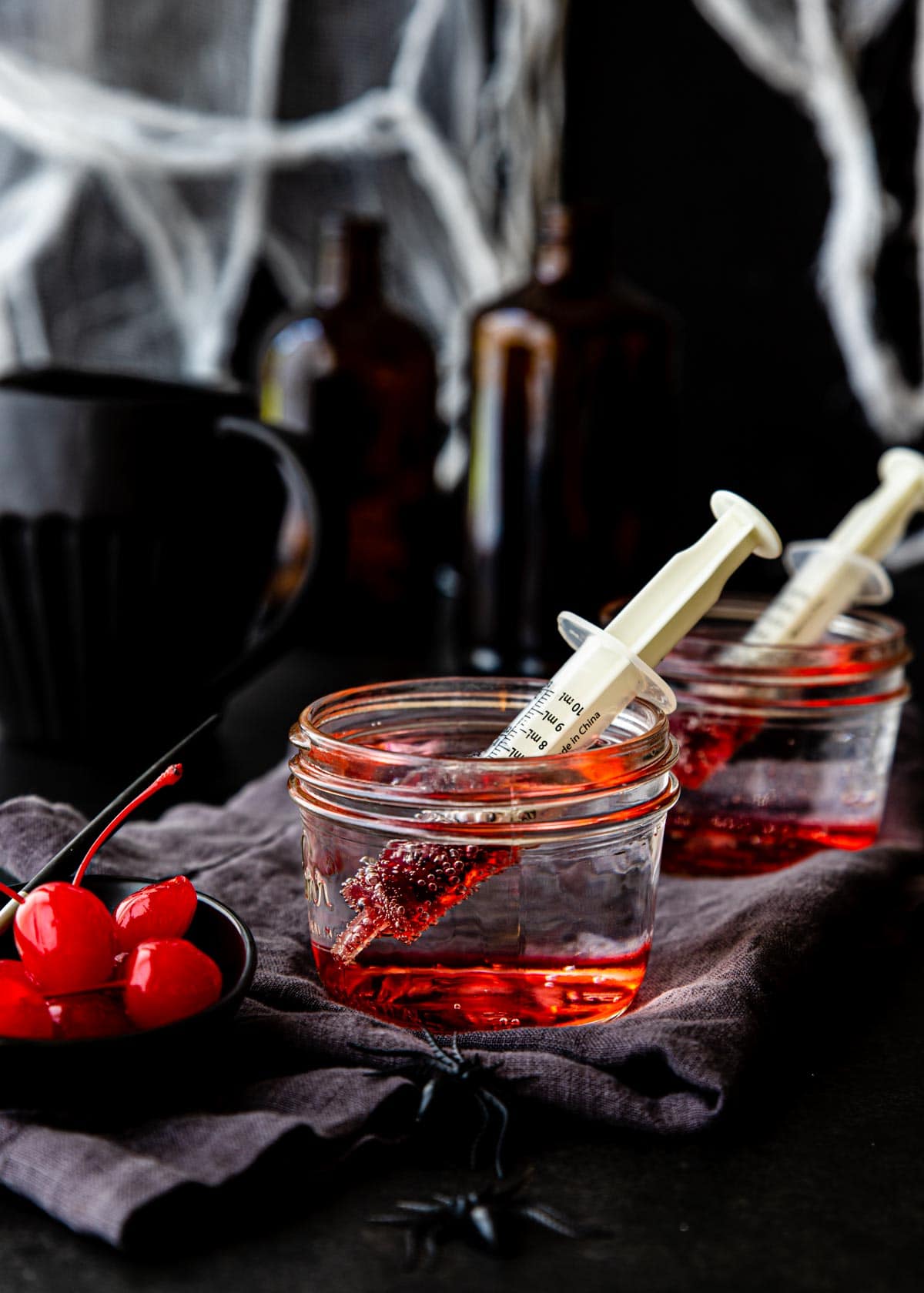 bloody Shirley temples in mason jars with syringes