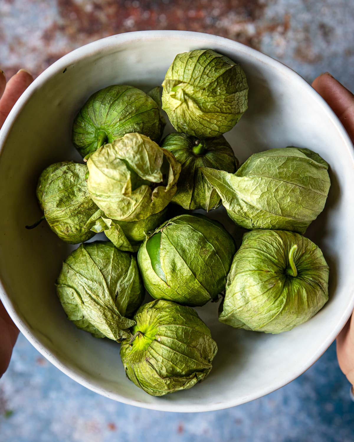 raw green tomatillos in a bowl