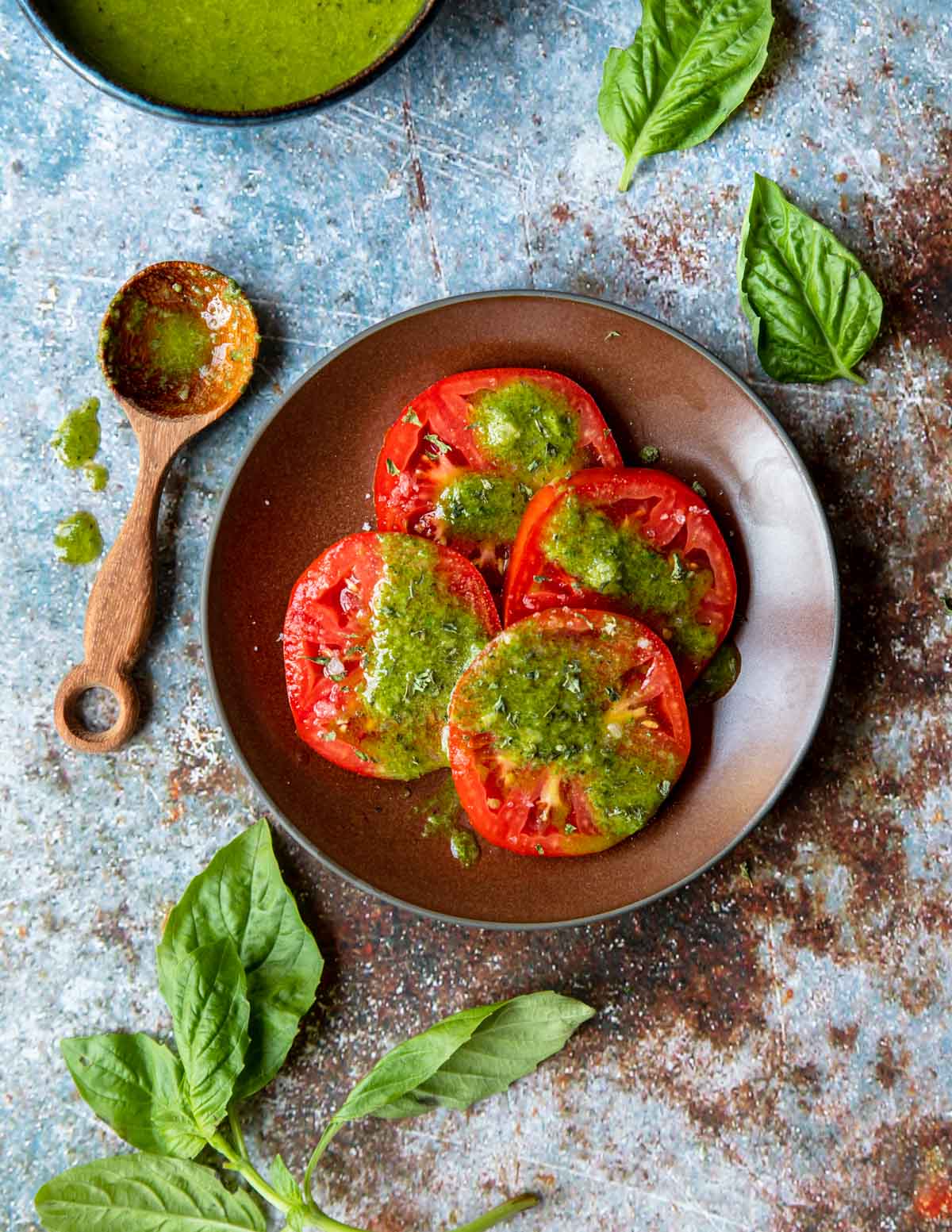 fresh garden tomatoes, sliced, with basil vinaigrette drizzled over top