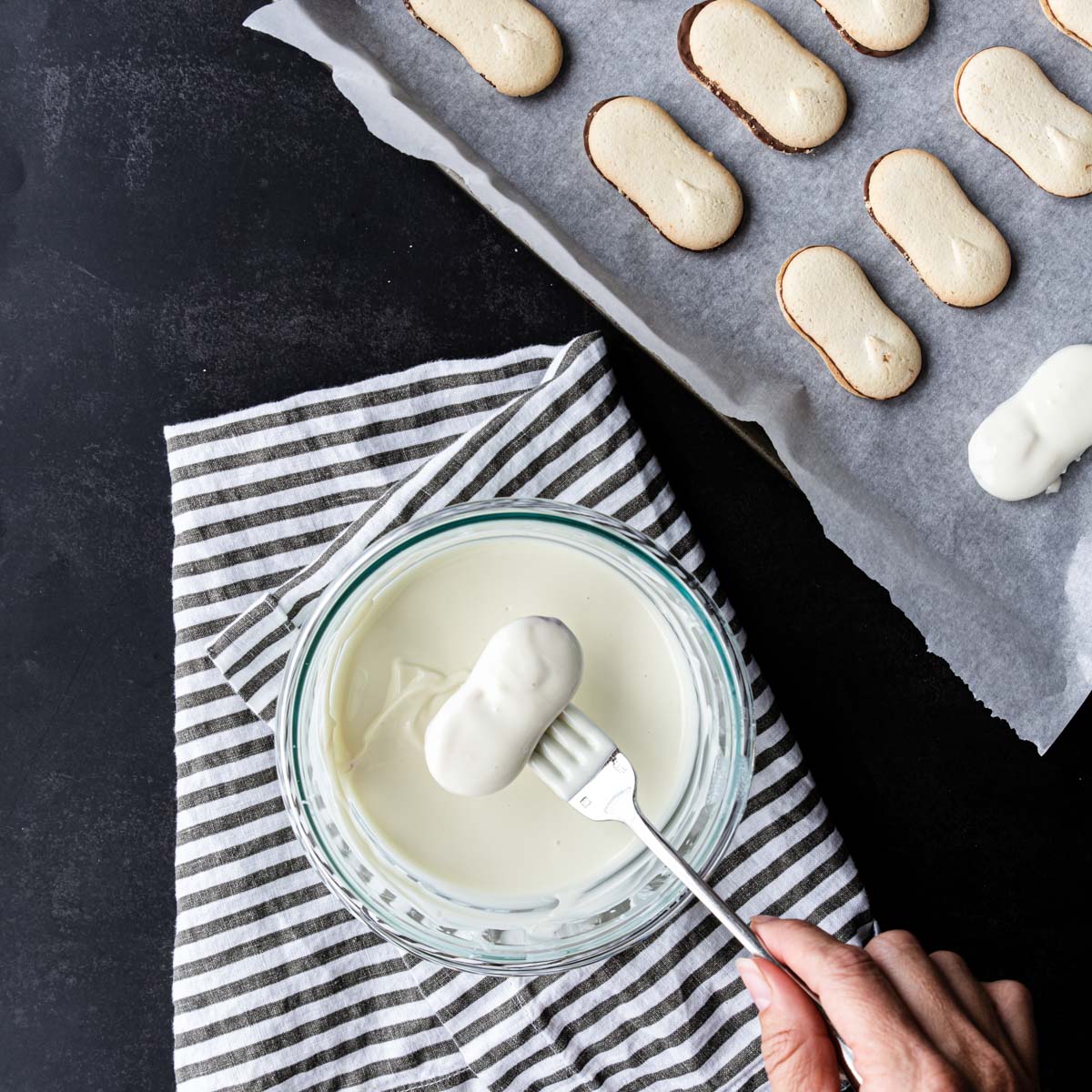 dipping a cookie in white chocolate