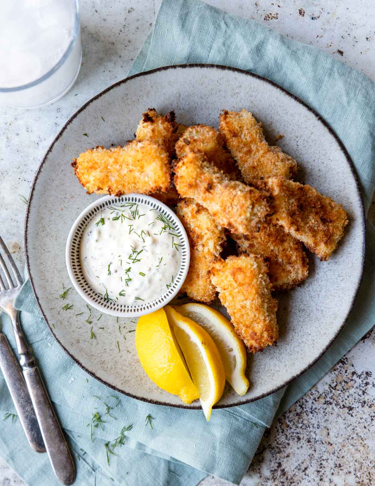 Tartar Sauce in a small bowl on a plate of fish sticks