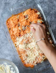 sprinkling cheese mixture over stuffed shells