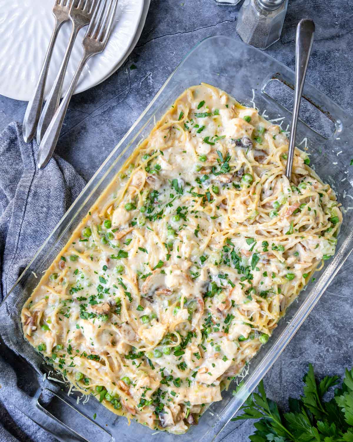 chicken tetrazzini on a table with plates and forks