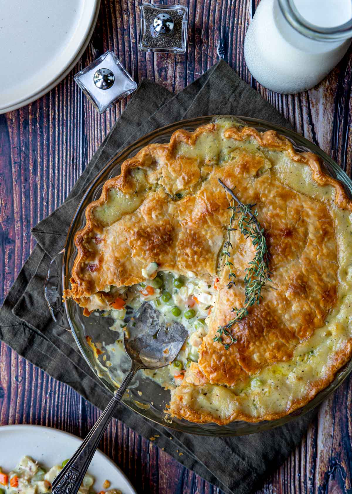 turkey pot pie with a golden crust and sprig of thyme
