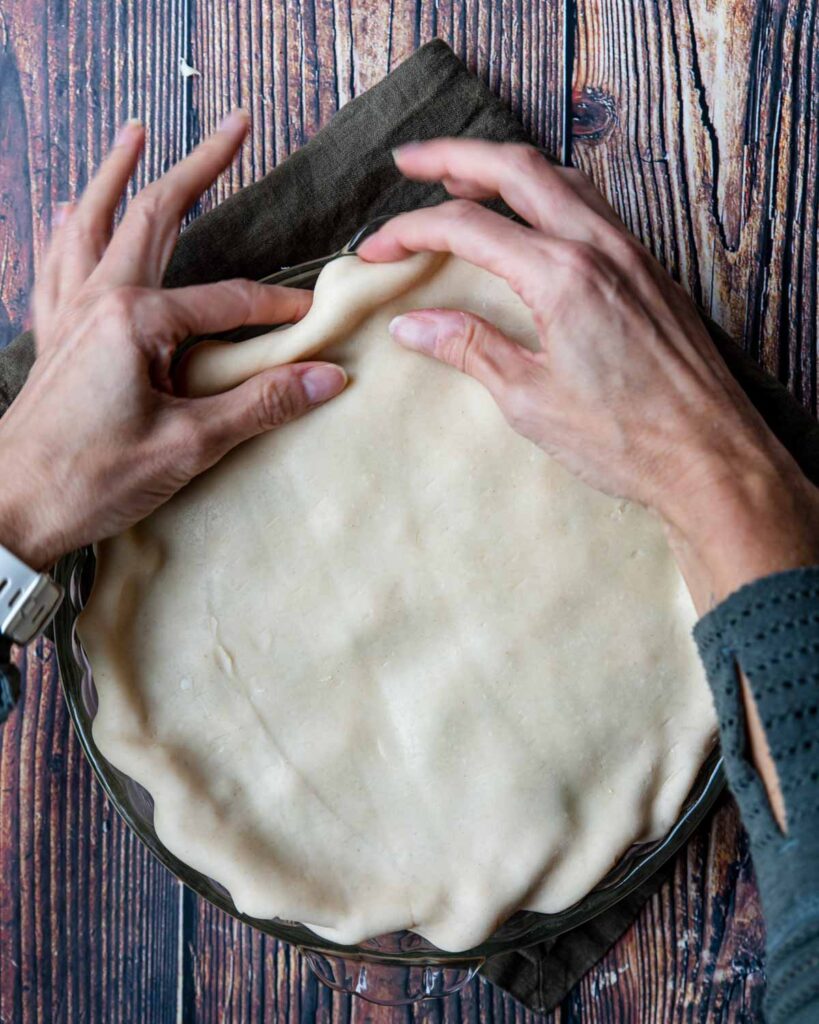 showing how to fold a top crust over a bottom crust