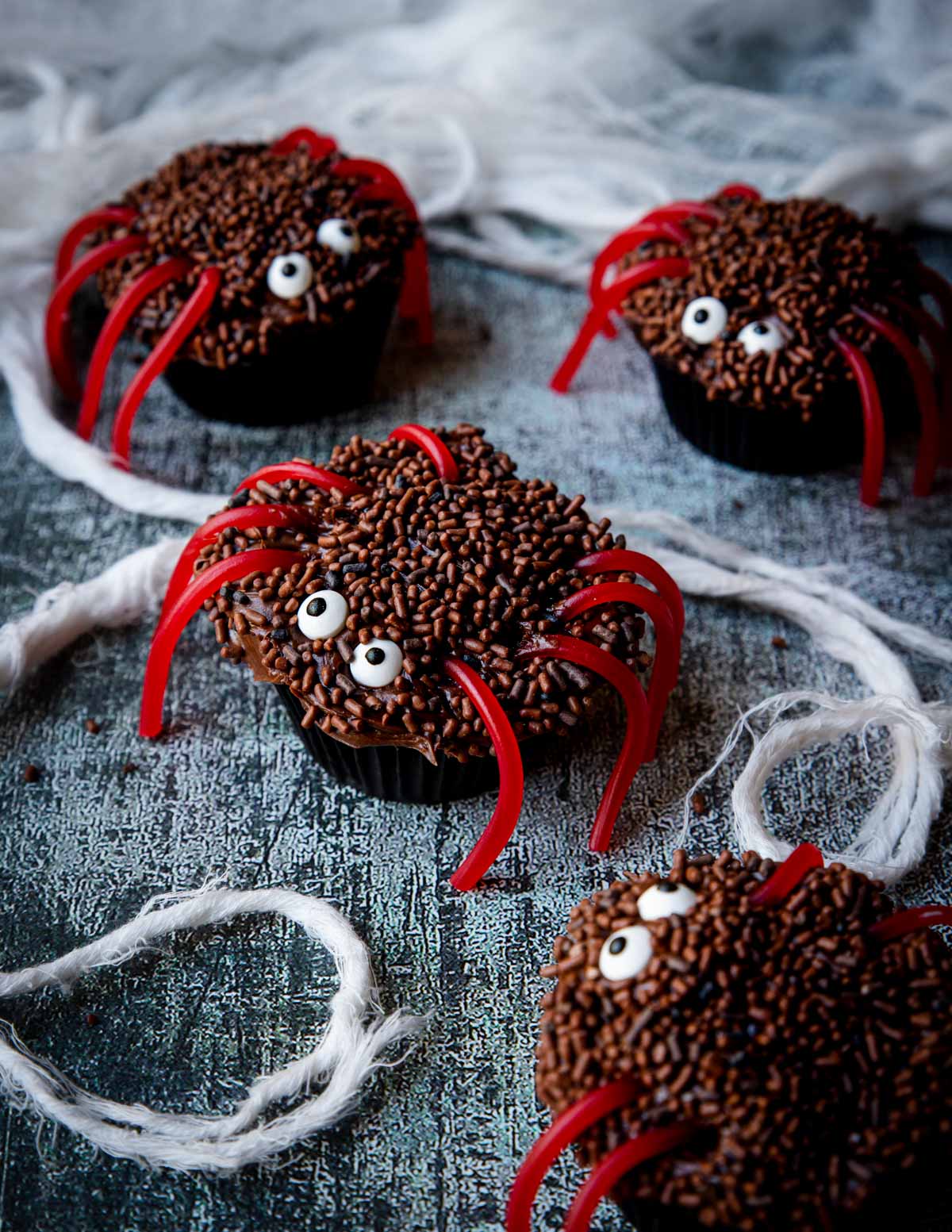 Halloween Spider Cupcakes on a table with a spider web