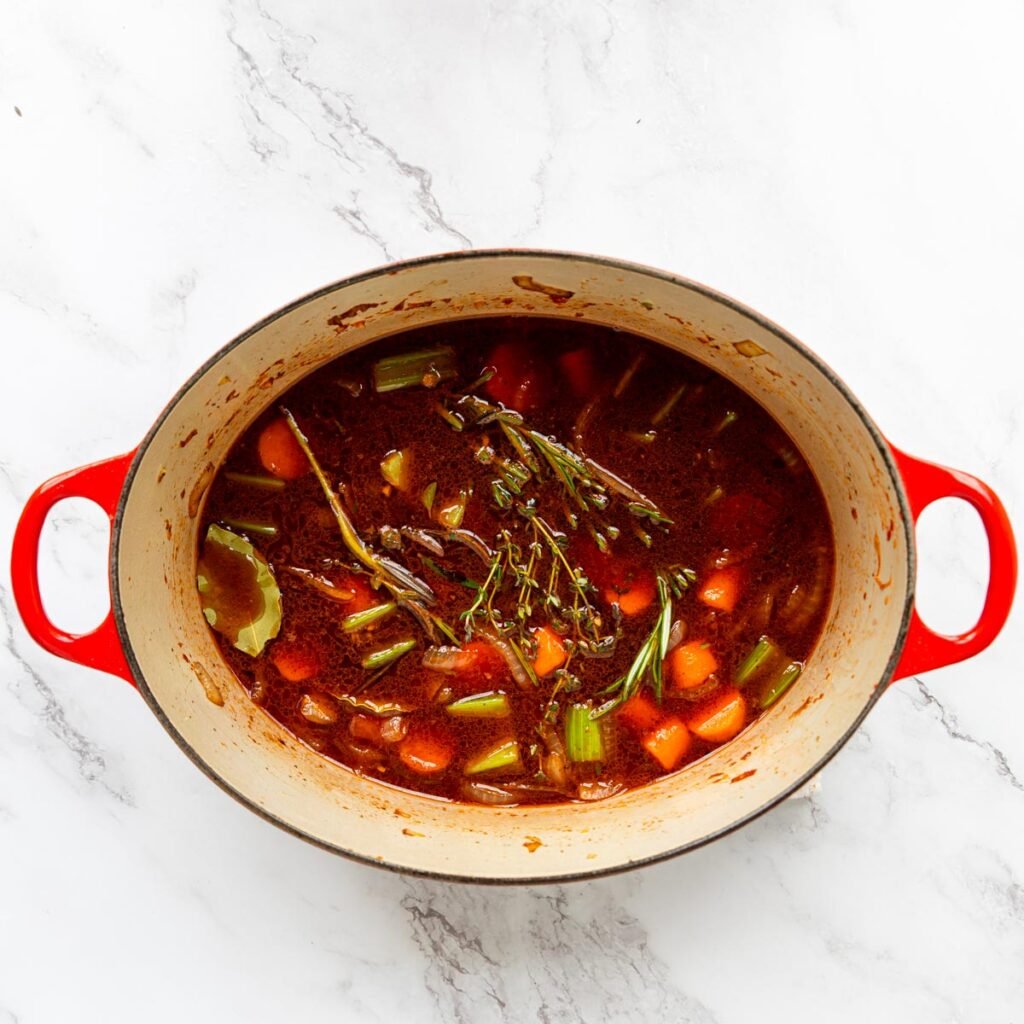 beef broth, red wine, herbs in a dutch oven