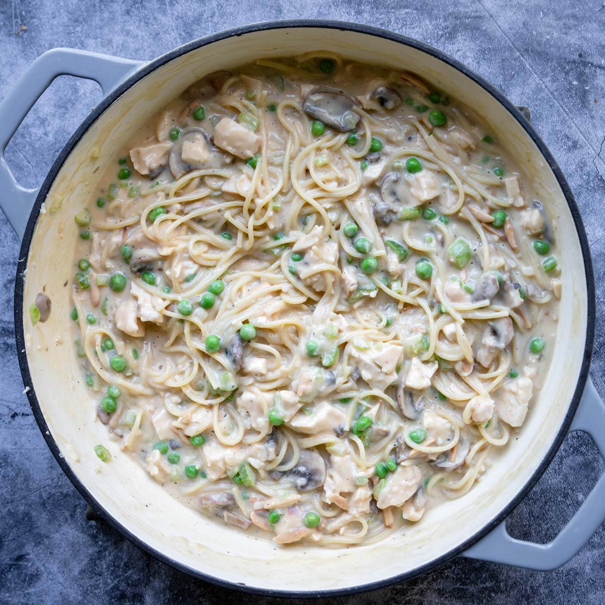 spaghetti, chicken and almonds in a cream sauce with peas and mushrooms