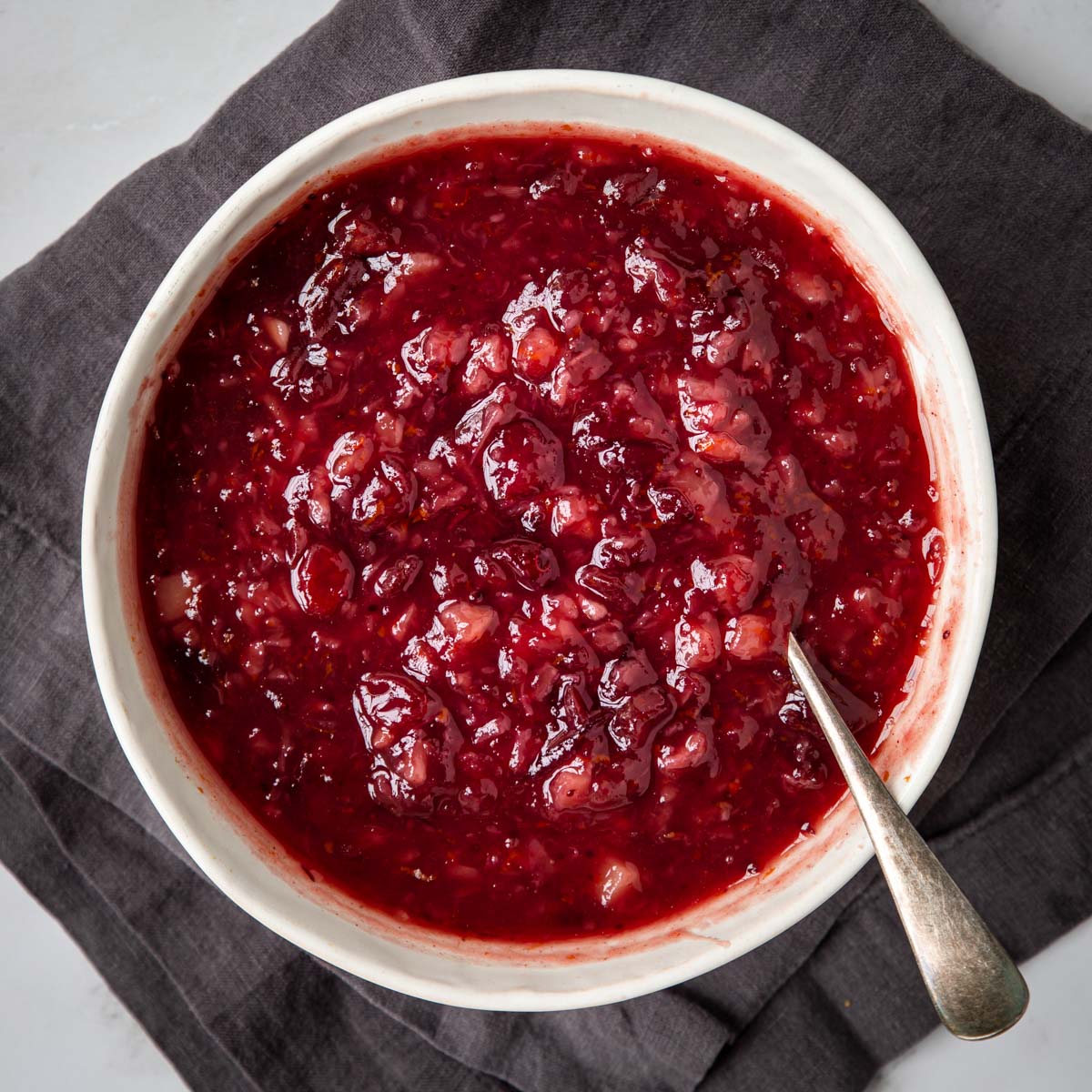 a cowl of cranberry sauce with a spoon for serving
