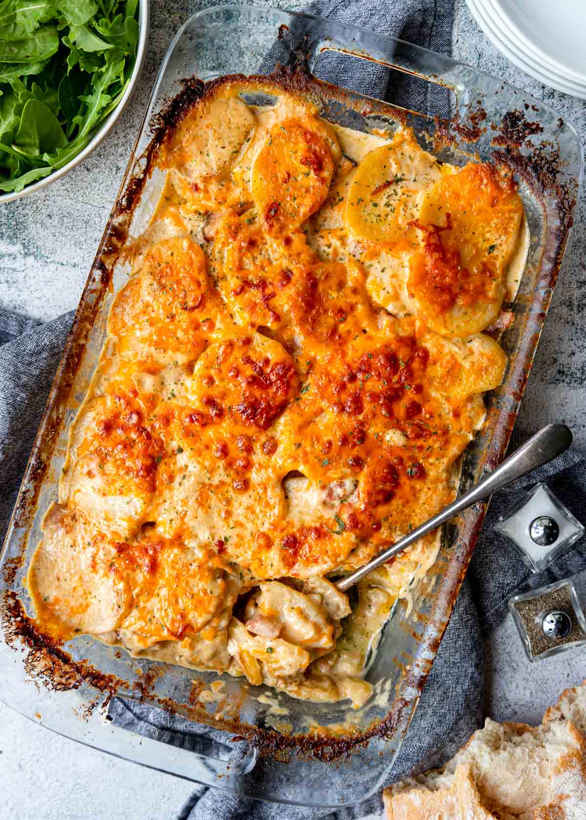 scalloped potatoes and ham in a 9x13 casserole dish on a table