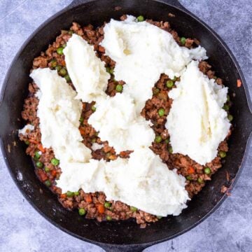 dollops of mashed potatoes on top of Shepherd's Pie Filling