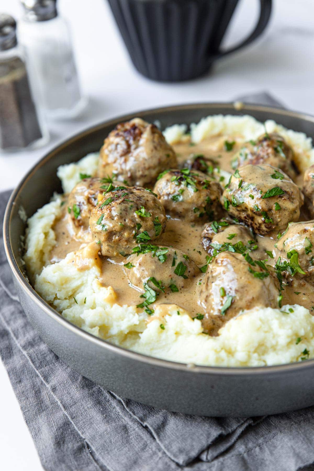 mashed potatoes topped with meatballs and brown sauce