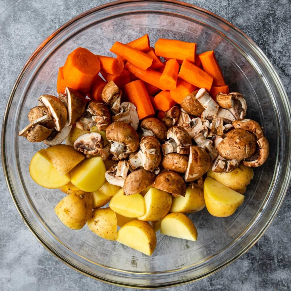 potatoes, carrots and mushrooms in a bowl