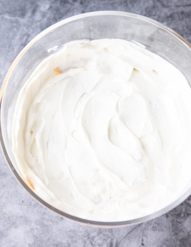 whipped cream spread in a trifle bowl
