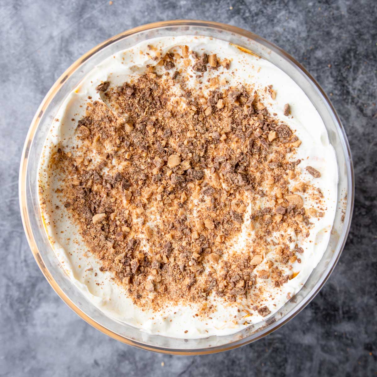 toffee bits sprinkled on top of a Thanksgiving Pumpkin Trifle