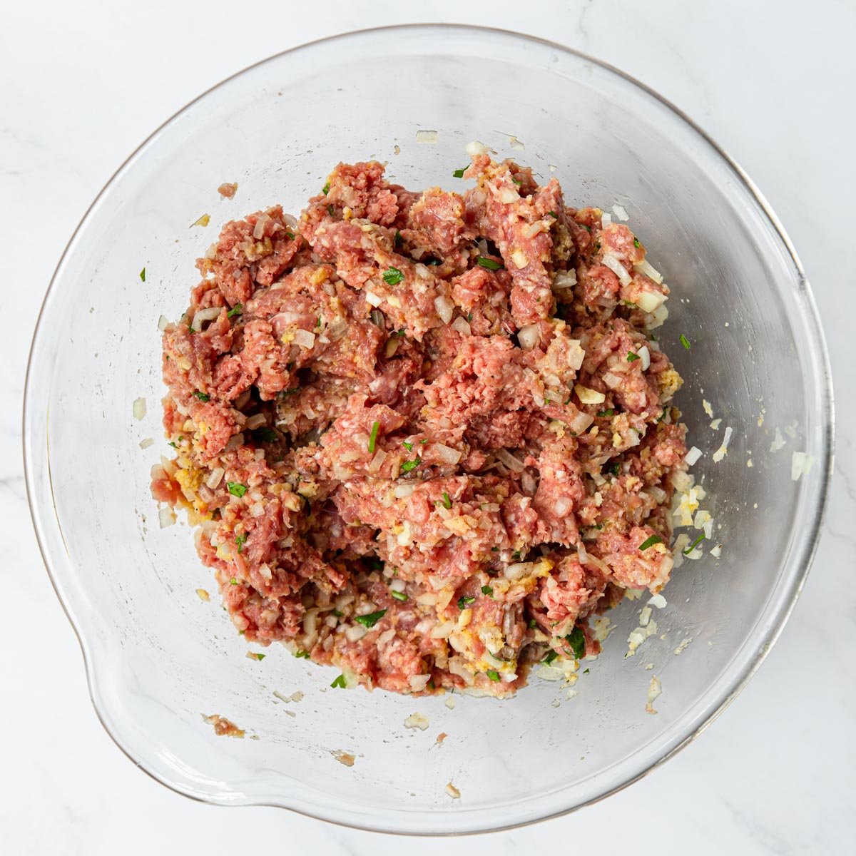 ground beef, ground pork, panade and herbs in a bowl