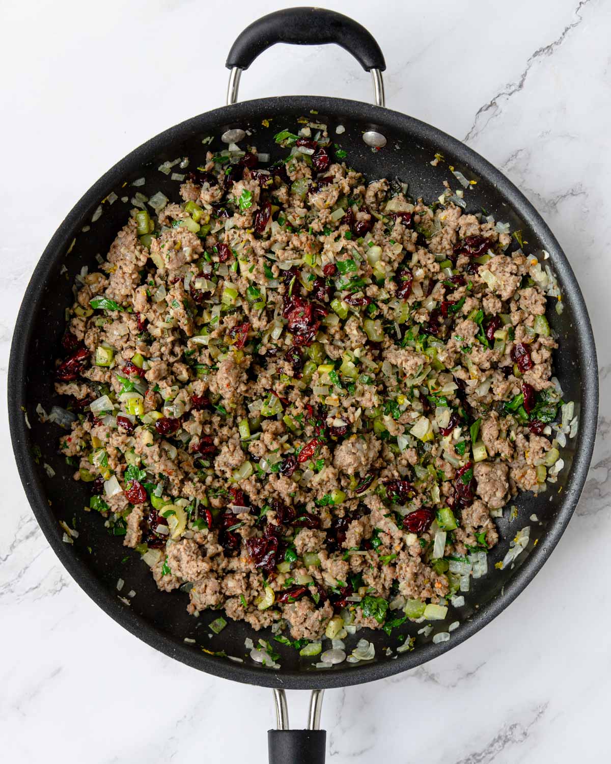sausage, onion, celery, dried cranberries and herbs in a skillet