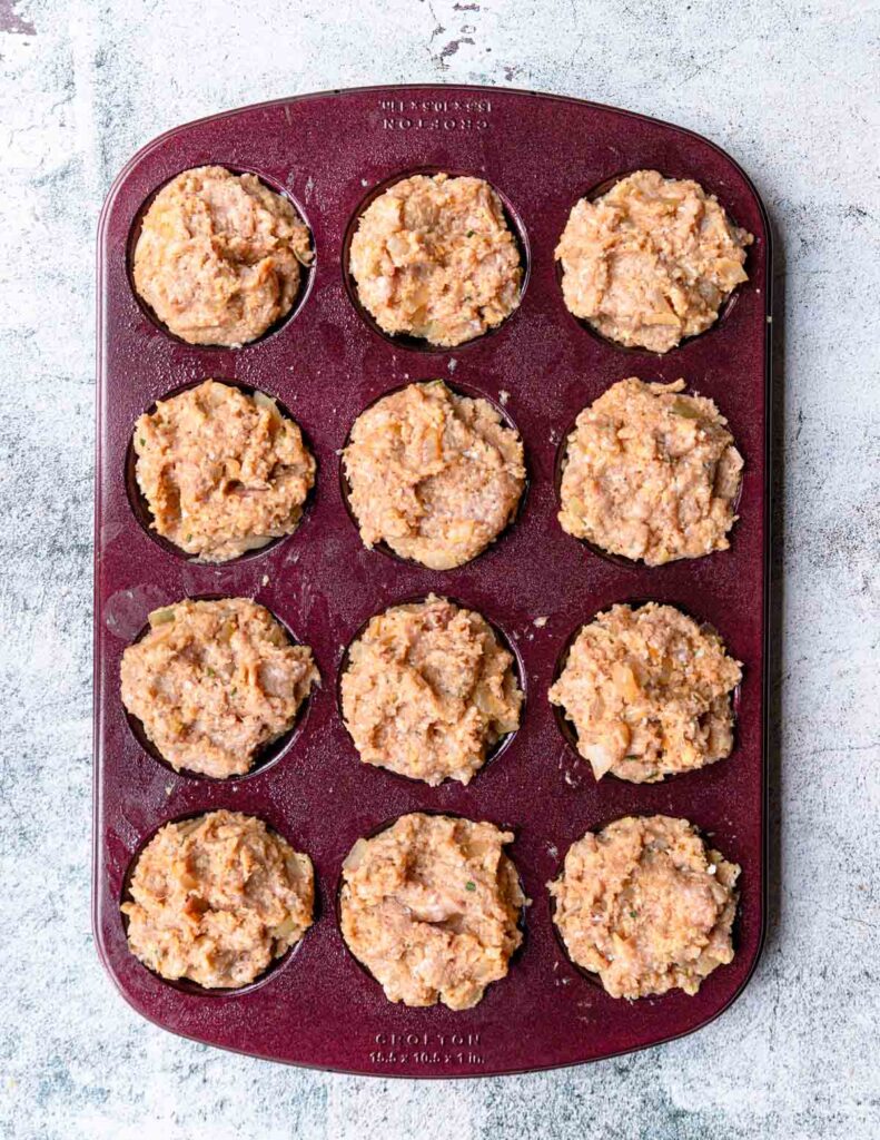 turkey mixture portioned into a muffin tin