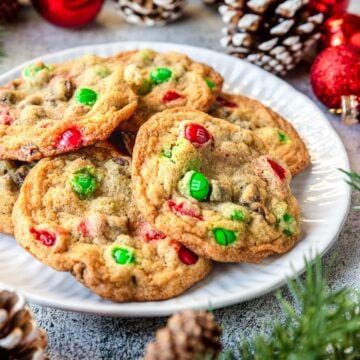 a plate of Christmas Chocolate Chip Cookies with red and green M&M's