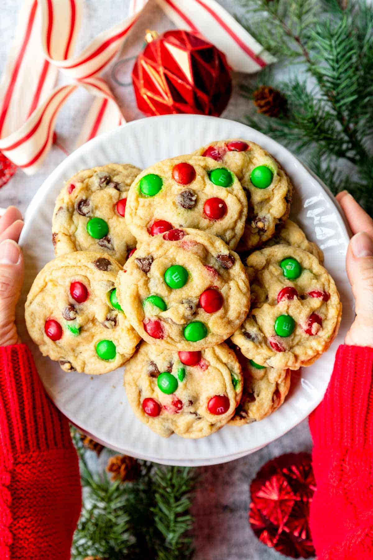 A plate of Christmas Chocolate Chip Cookies with red and green M&M's