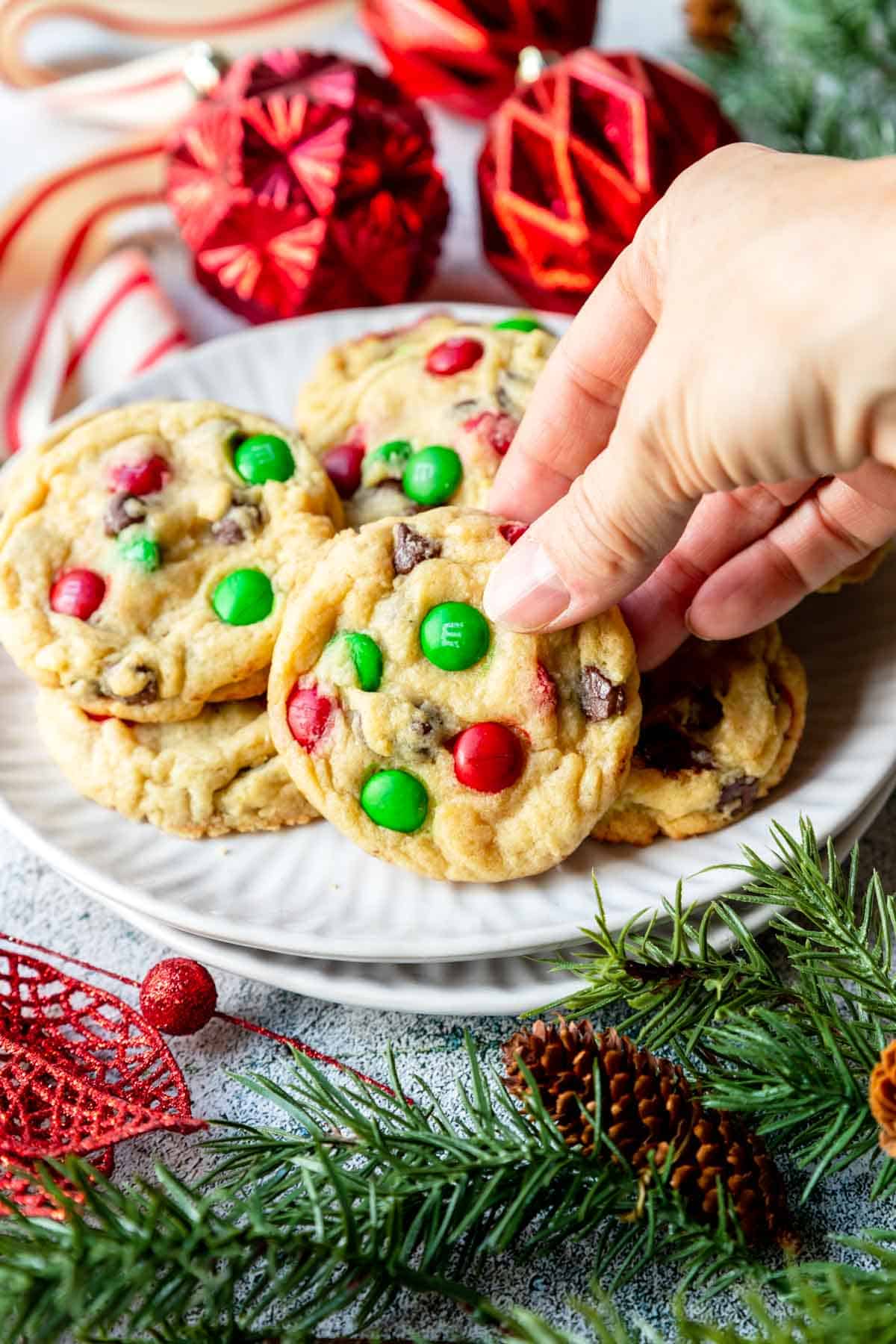 a hand grabbing a Christmas Chocolate Chip Cookie