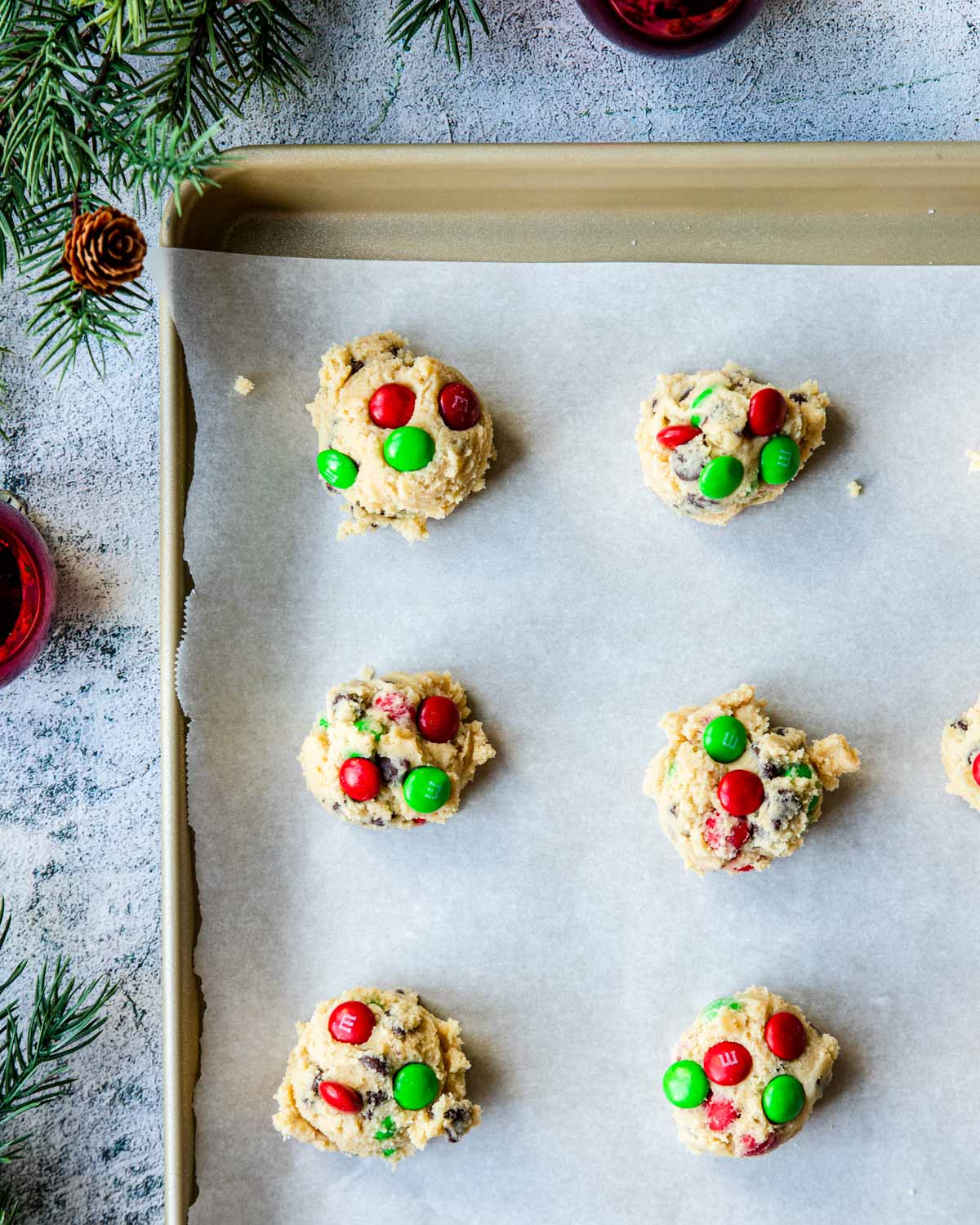cookie dough balls with red and green M&M's pressed on the outside