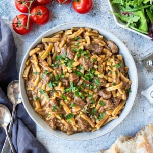 Instant Pot Beef and Noodles Recipe in a bowl with a salad to the side