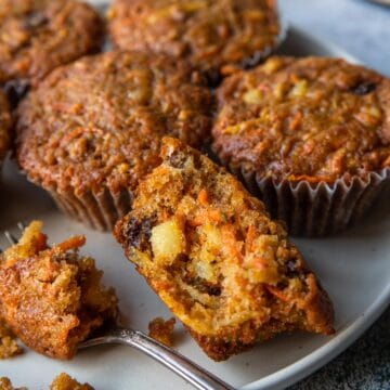 a morning glory muffin cut open to show all the fruits, veggies and nuts
