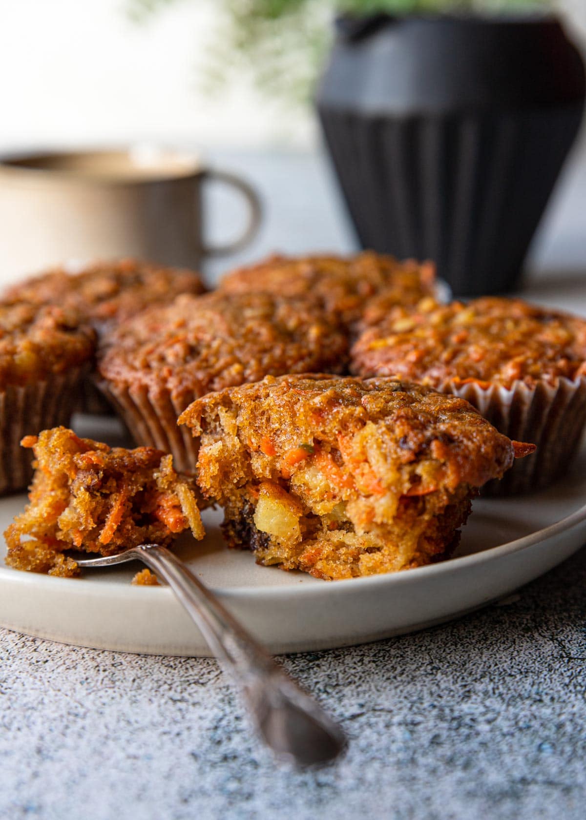 a plate of morning glory muffins with one cut open
