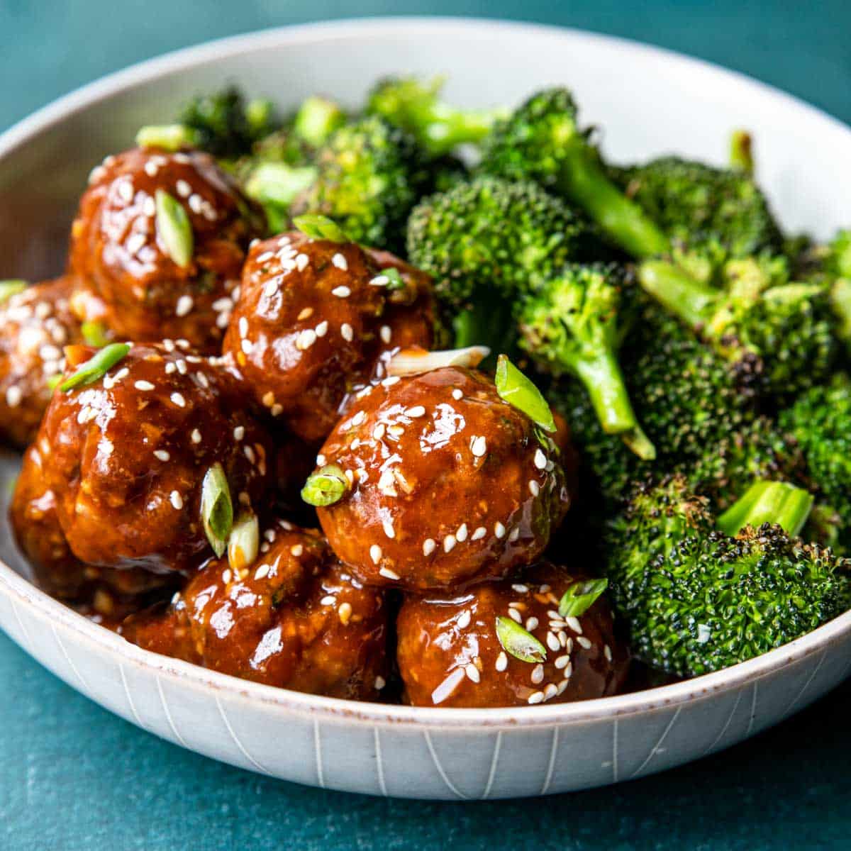 Saucy Hoisin Meatballs in a bowl with broccoli
