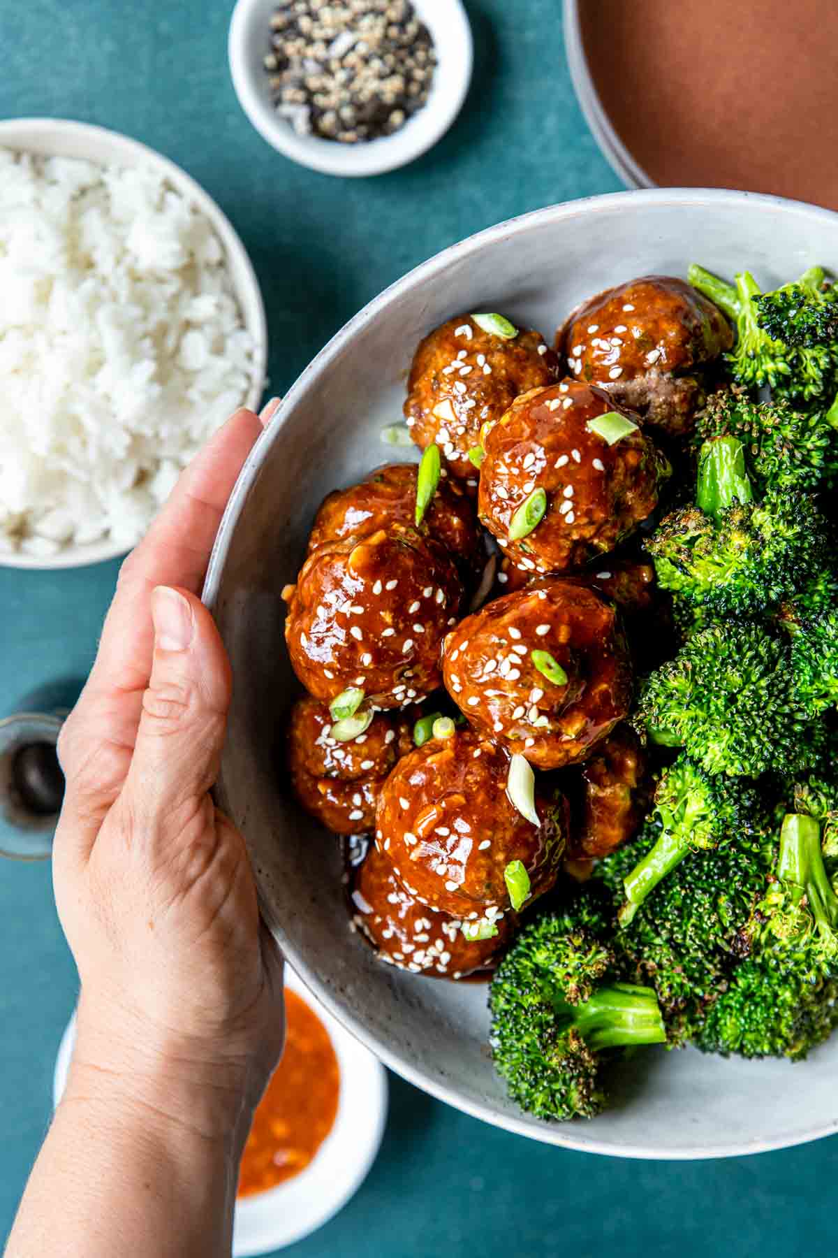 Hoisin Meatballs being served with broccoli and rice