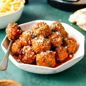 meatballs in a bowl with a spoon
