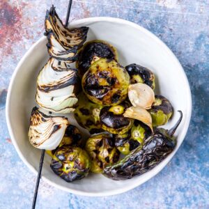 grilled tomatillos, onion, garlic and jalapeno in a bowl