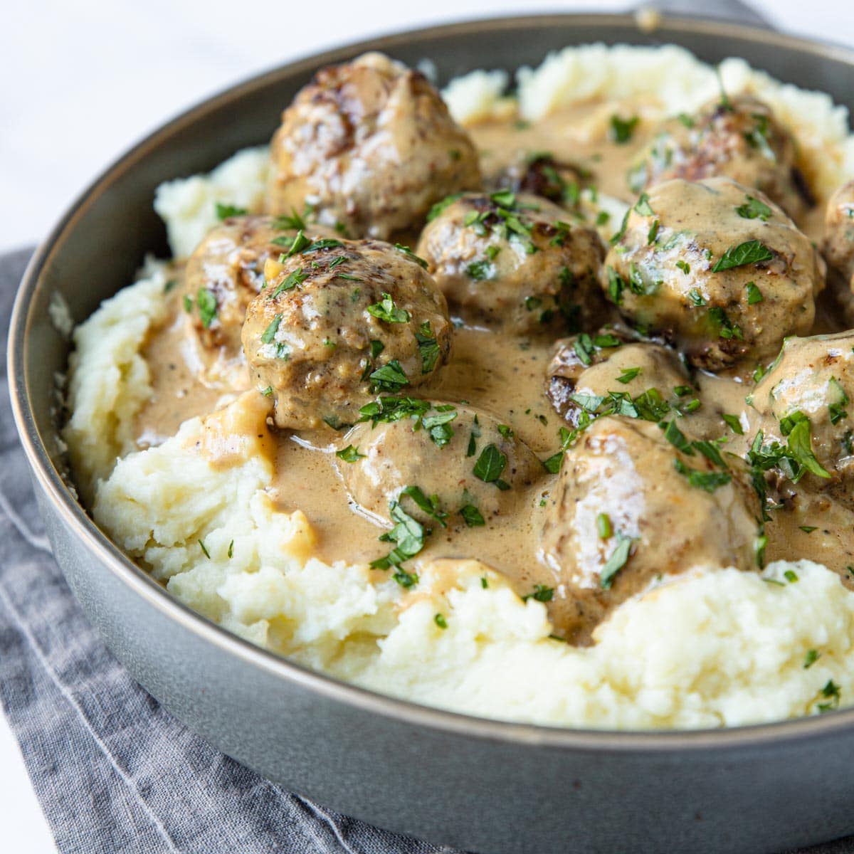 mashed potatoes and Swedish Meatballs in a gray bowl