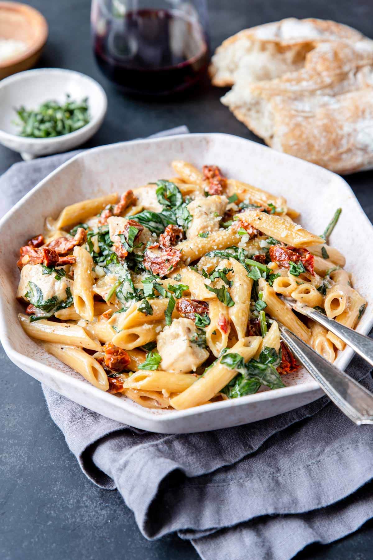 Instant Pot Tuscan Pasta in a bowl with wine and bread