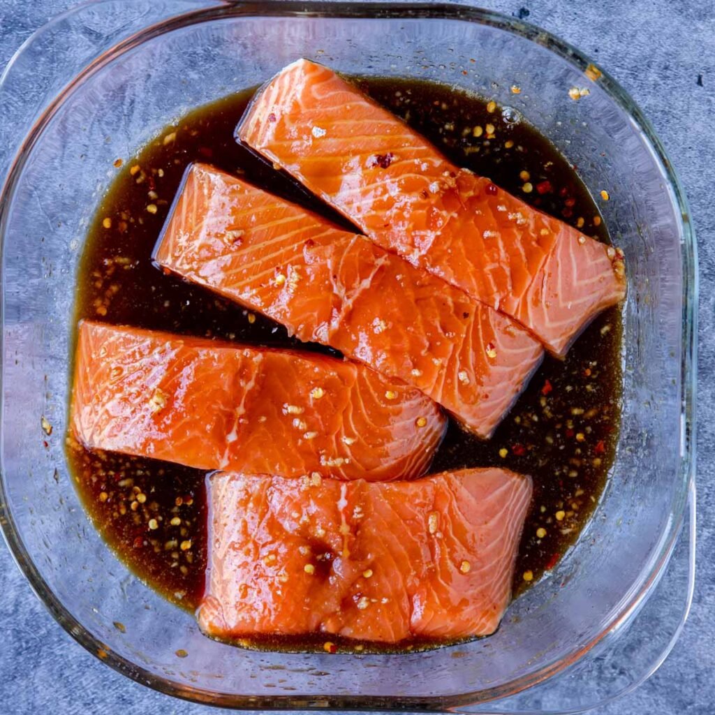 salmon filets marinating in Asian marinade