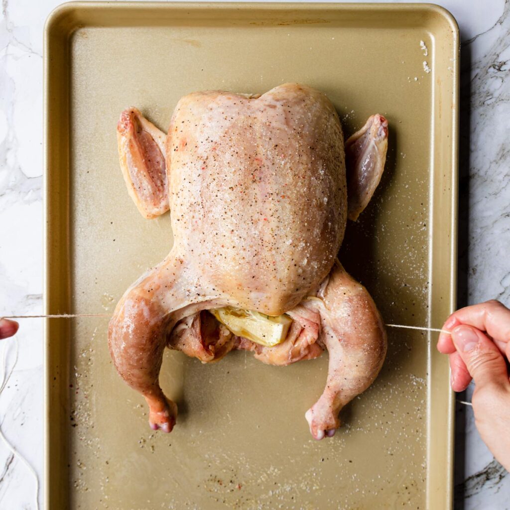 showing how to truss a chicken for roasting
