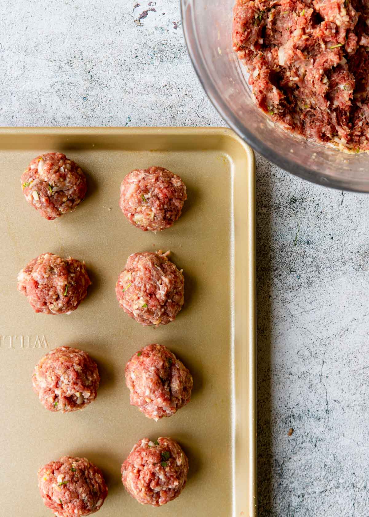 showing meatballs on a baking sheet to show the size, about like a ping pong ball
