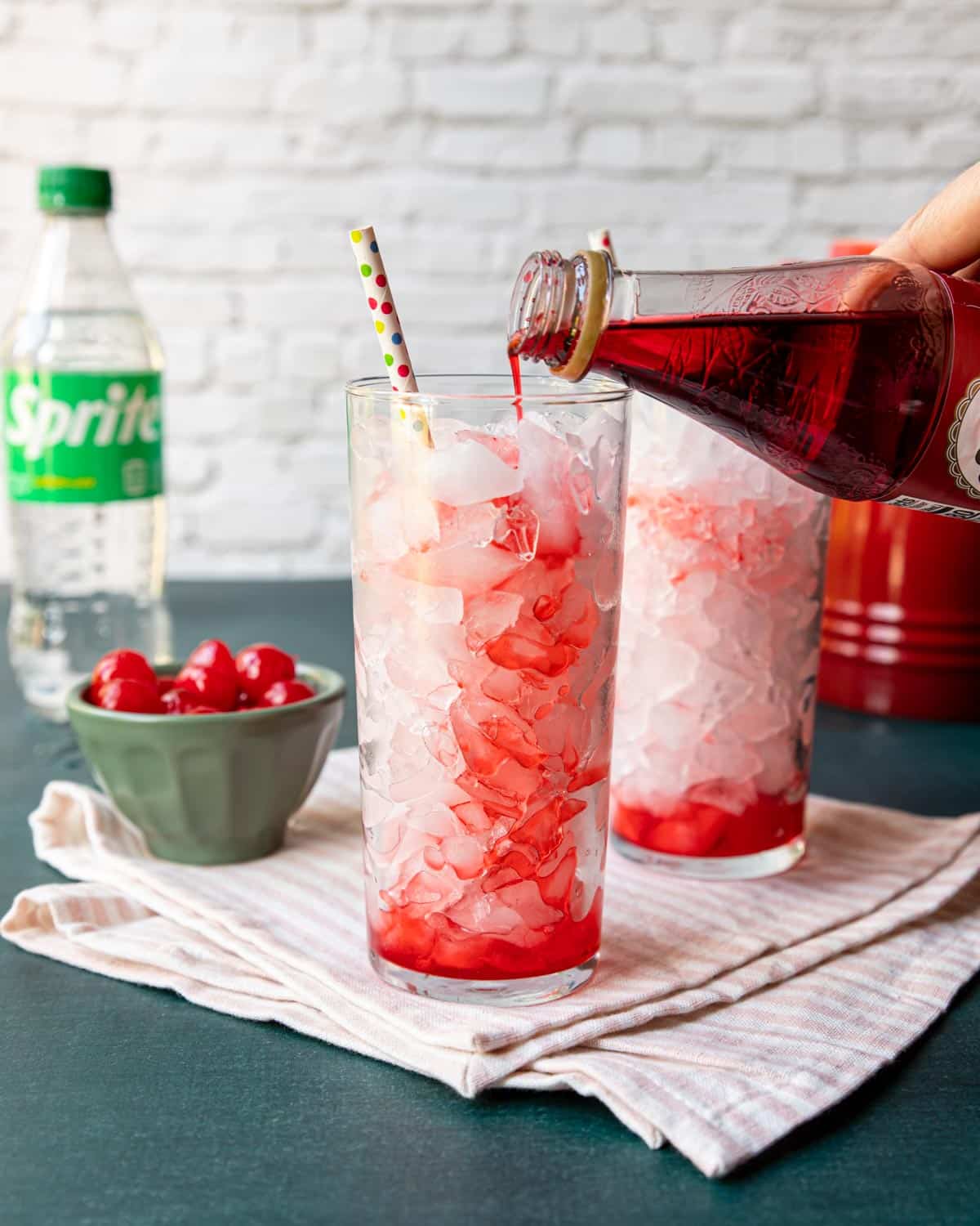 grenadine syrup being poured over ice