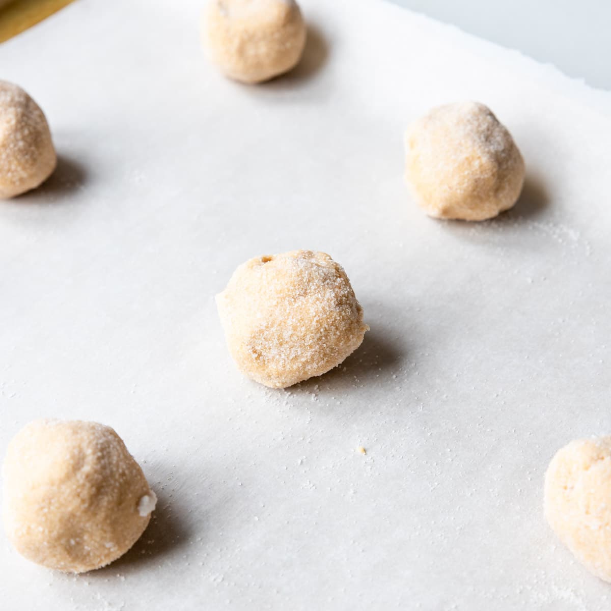 soft peanut butter cookie balls on a baking sheet