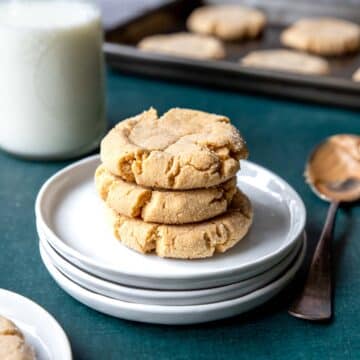 three soft peanut butter crinkle cookies on a plate