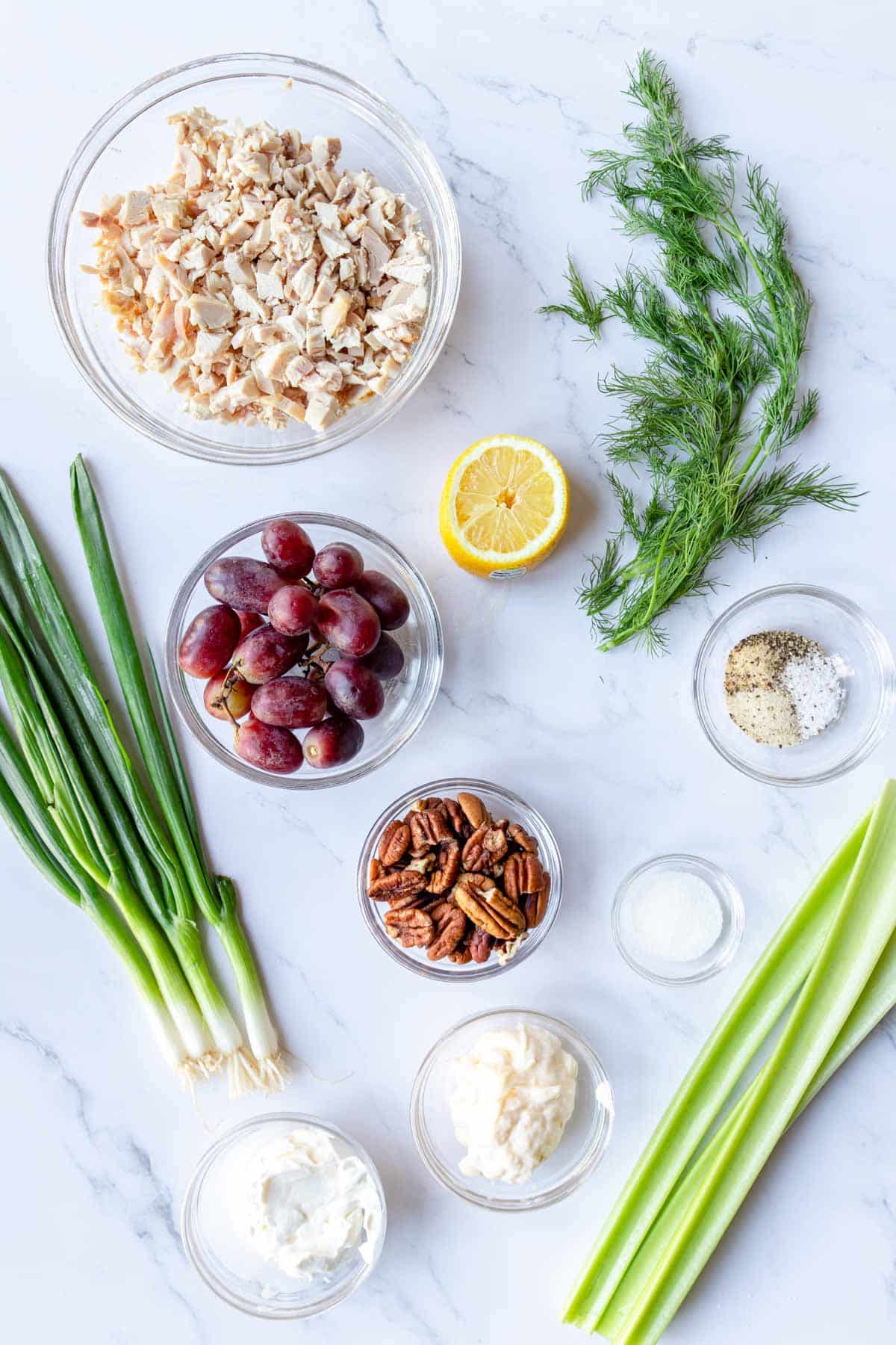 Ingredients to make chicken salad with grapes on a table 