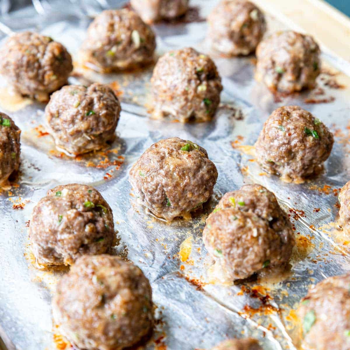 baked meatballs on a baking sheet