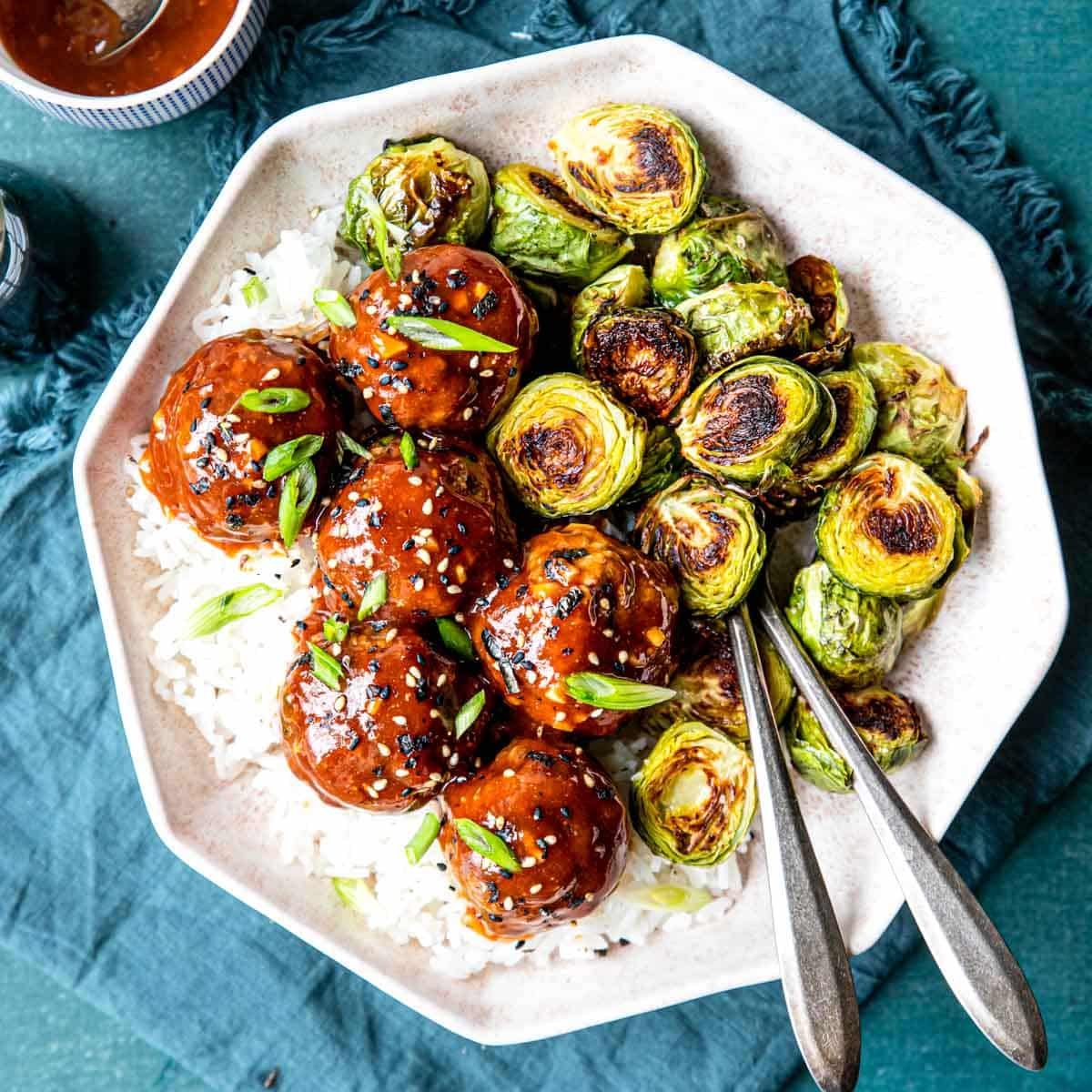 Sticky Asian Meatballs over rice with brussels sprouts on the side