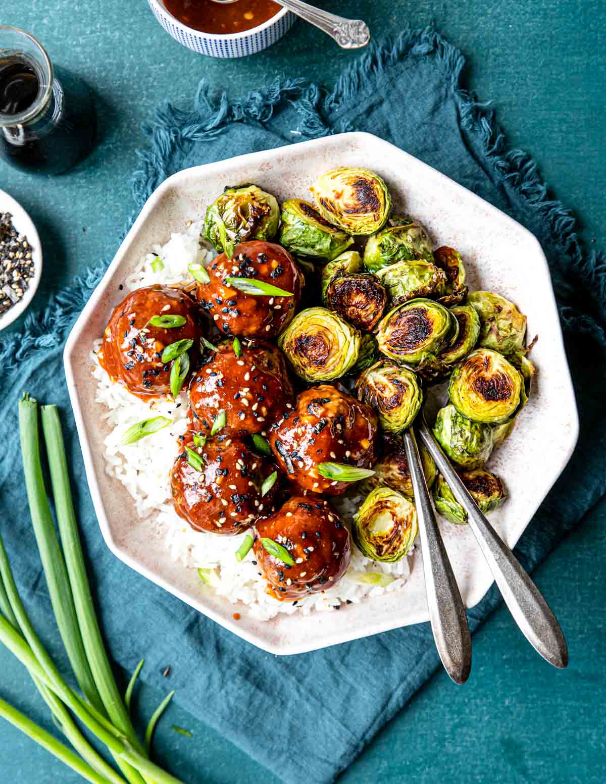 a large plate with Asian Style Meatballs, rice and roasted brussels sprouts
