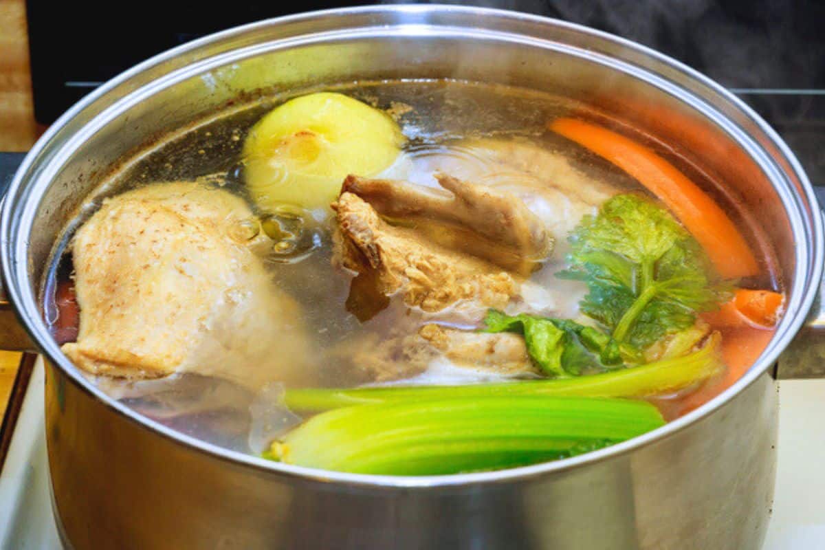 chicken stock simmering in a pot